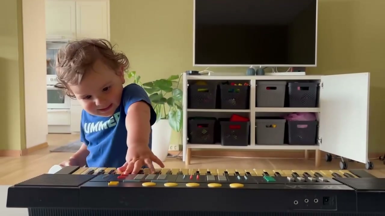 Frame from the video: a child at an electronic keyboard